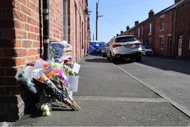 Flowers and messages of tribute to Barry Dawson and his family.