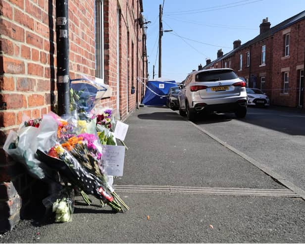 Flowers and messages of tribute to Barry Dawson and his family.