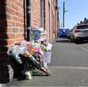 Flowers and messages of tribute to Barry Dawson and his family.