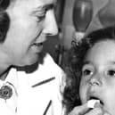 Four year old Candy Hill gets her lump of sugar with the anti vaccine on it from Nurse Spark at the Health Department in Stanhope Parade in 1965.