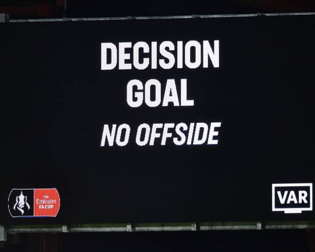 The scoreboard displays the VAR (Video Assistant Referee) decision of a goal after a review for a possible offside.  