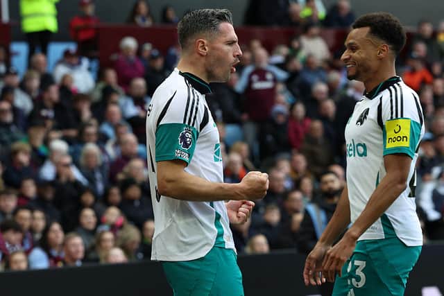 Newcastle United's Swiss defender #05 Fabian Schar (L) celebrates with Newcastle United's English midfielder #23 Jacob Murphy (R) after scoring their first goal during the English Premier League football match between Aston Villa and Newcastle United at Villa Park in Birmingham, central England on April 19, 2025. (Photo by Darren Staples / AFP)