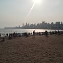 Families gather before sunset on Chowpatty beach in Mumbai