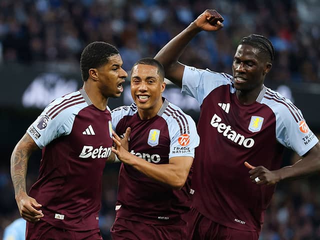 Marcus Rashford of Aston Villa celebrates scoring his team's first goal with Youri Tielemans and Amadou Onana during the Premier League match between Manchester City FC and Aston Villa FC at Etihad Stadium on April 22, 2025 in Manchester, England. (Photo by Carl Recine/Getty Images)