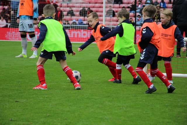 Children playing on the Stadium of Light pitch.