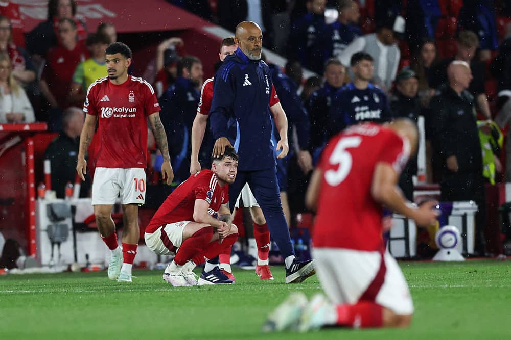 Nottingham Forest's Portuguese manager Nuno Espirito Santo (rear) comforts Nottingham Forest's Welsh defender #07 Neco Williams at the end of the English Premier League football match between Nottingham Forest and Brentford at The City Ground in Nottingham, central England, on May 1, 2025. Brentford wins 2 - 0 against Nottingham Forest. (Photo by Darren Staples / AFP) / RESTRICTED TO EDITORIAL USE. No use with unauthorized audio, video, data, fixture lists, club/league logos or 'live' services. Online in-match use limited to 120 images. An additional 40 images may be used in extra time. No video emulation. Social media in-match use limited to 120 images. An additional 40 images may be used in extra time. No use in betting publications, games or single club/league/player publications. /  (Photo by DARREN STAPLES/AFP via Getty Images)          