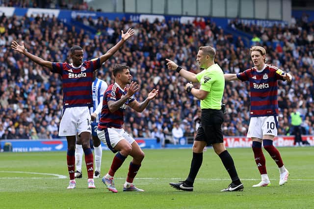 Newcastle United player react to referee Craig Pawson penalty decision prior to it being over-turned during the Premier League match between Brighton & Hove Albion FC and Newcastle United FC at Amex Stadium on May 04, 2025 in Brighton, England. (Photo by Charlie Crowhurst/Getty Images)