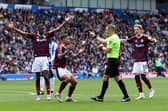 Newcastle United player react to referee Craig Pawson penalty decision prior to it being over-turned during the Premier League match between Brighton & Hove Albion FC and Newcastle United FC at Amex Stadium on May 04, 2025 in Brighton, England. (Photo by Charlie Crowhurst/Getty Images)