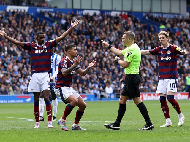 Newcastle United player react to referee Craig Pawson penalty decision prior to it being over-turned during the Premier League match between Brighton & Hove Albion FC and Newcastle United FC at Amex Stadium on May 04, 2025 in Brighton, England. (Photo by Charlie Crowhurst/Getty Images)