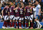 Newcastle United's English head coach Eddie Howe talks to his players. 