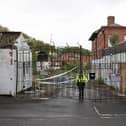 A police officer stands guard outside Fairfield Industrial Park in the Bill Quay area of Gateshead on Sunday morning, where the body of 14 year old Layton Carr was discovered inside a building after firefighters rushed to the scene shortly after 8pm on Friday night and extinguished a blaze. 
