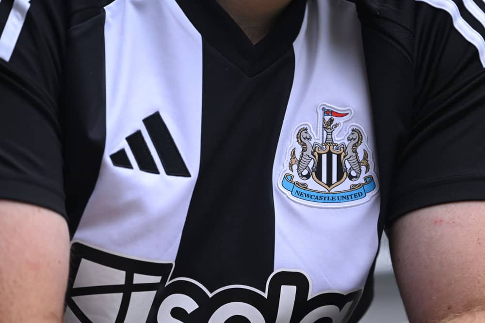 The Adidas logo and club badge are seen on the shirt of the new home kit during the Premier League match between Newcastle United FC and Southampton FC at St James' Park on August 17, 2024 in Newcastle upon Tyne, England. (Photo by Stu Forster/Getty Images)