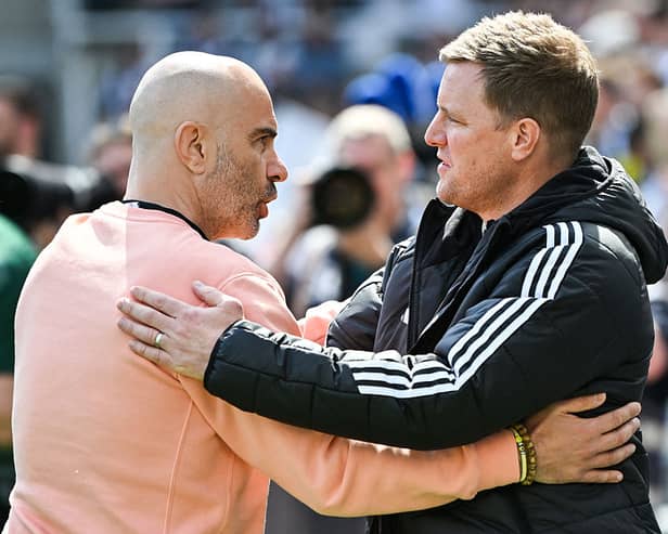 Chelsea's Italian head coach Enzo Maresca (L) and Newcastle United's English head coach Eddie Howe (R) hugh each other at the start of the English Premier League football match between Newcastle United and Chelsea at St James' Park in Newcastle-upon-Tyne, north east England on May 11, 2025. (Photo by ANDY BUCHANAN / AFP) /