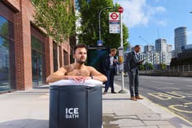 A commuter takes an ice bath at a London bus stop