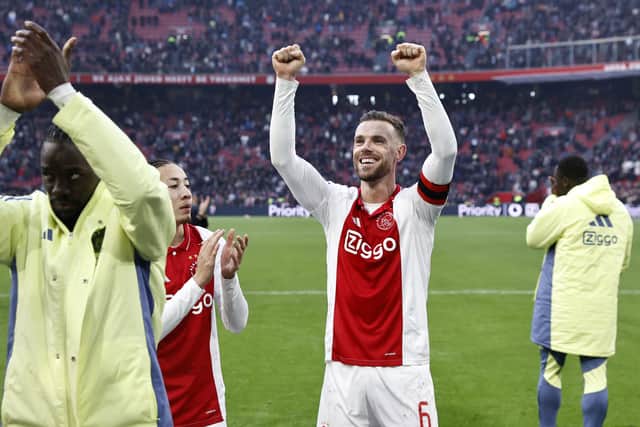 Ajax' Dutch midfielder Kian Fitz-Jim and Ajax's English midfielder #6 Jordan Henderson celebrate the victory of their team at the end of the Dutch Eredivisie football match between AFC Ajax and Feyenoord at the Johan Cruijff ArenA in Amsterdam, on February 2, 2025. Ajax won 2-1 over Feyenoord