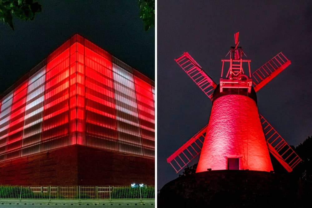 The Beacon of Light and Fulwell Mill illuminated in red and white.