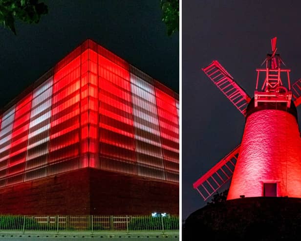The Beacon of Light and Fulwell Mill illuminated in red and white.