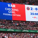 The LED screen displays a message from VAR which reads "Checking Goal, possible offside  during the Sky Bet Championship Play-Off Final match between Sheffield United and Sunderland at Wembley Stadium on May 24, 2025 in London, England. This weekend's EFL play-off matches at Wembley will all kick-off one minute late, to raise awareness for the âEvery Minute Mattersâ campaign, which aims to encourage people to learn CPR. (Photo by Mike Hewitt/Getty Images)