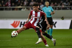 Charalampos Kostoulas of Olympiacos FC is challenged by Marko Jankovi of  Qarabag FK during the UEFA Europa League 2024/25 League Phase MD8 match between Olympiacos FC and Qarabag FK at Stadio Georgios Karaiskakis on January 30, 2025 in Piraeus, Greece. (Photo by Milos Bicanski/Getty Images)