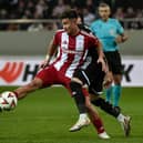 Charalampos Kostoulas of Olympiacos FC is challenged by Marko Jankovi of  Qarabag FK during the UEFA Europa League 2024/25 League Phase MD8 match between Olympiacos FC and Qarabag FK at Stadio Georgios Karaiskakis on January 30, 2025 in Piraeus, Greece. (Photo by Milos Bicanski/Getty Images)