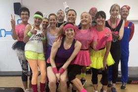 Gym Group staff and members at their 80s-themed charity aerobics fundraiser.