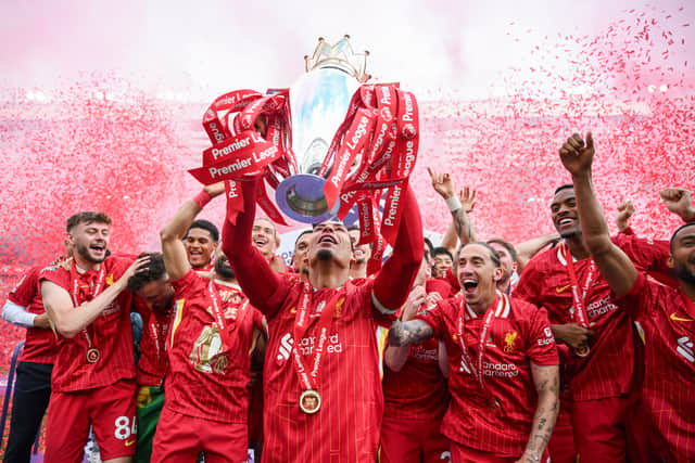 Virgil van Dijk of Liverpool lifts the trophy after the Premier League match between Liverpool FC and Crystal Palace FC at Anfield on May 25, 2025 in Liverpool, England.