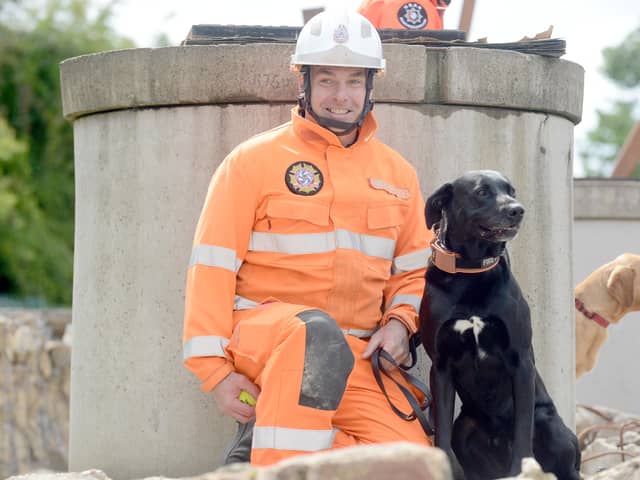  Watch manager Steve Carr with Merlin the search and rescue dog.
