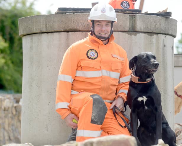  Watch manager Steve Carr with Merlin the search and rescue dog.