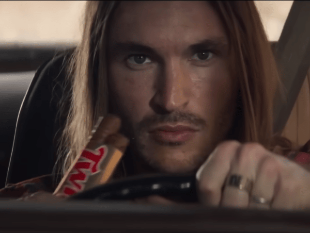 A television advert for Twix biscuits has been banned by the ASA for promoting "dangerous" and "irresponsible" driving