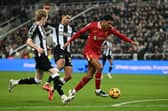 Jarrell Quansah and Anthony Gordon battle in the Premier League match between Liverpool and Newcastle | Getty Images