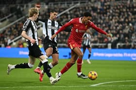 Jarrell Quansah and Anthony Gordon battle in the Premier League match between Liverpool and Newcastle | Getty Images