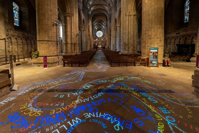 'The Words That Bind Us' by artist Nicola Anthony projected onto the cathedral floor.
