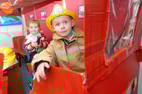 These two youngsters were having a great time in the dress-up area of the school.