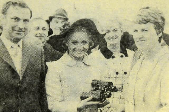 Shields Gazette competition winner Catherine Robertson receives her prize of a pair of binoculars from Golden Shot hostess Anne Aston in 1971.