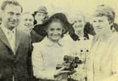 Shields Gazette competition winner Catherine Robertson receives her prize of a pair of binoculars from Golden Shot hostess Anne Aston in 1971.