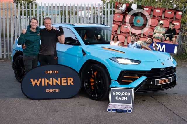 Christian Williams from BOTB presents Ady Godson with his massive prize