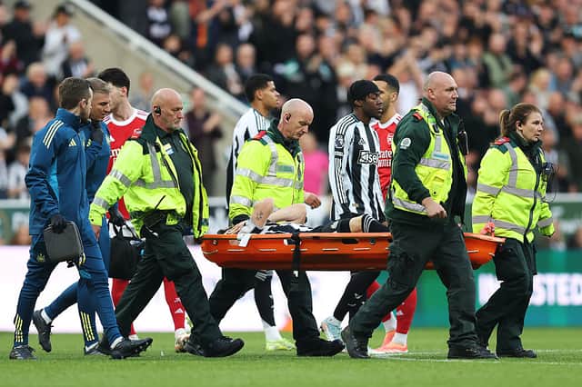 Tino Livramento is stretchered off against Arsenal.