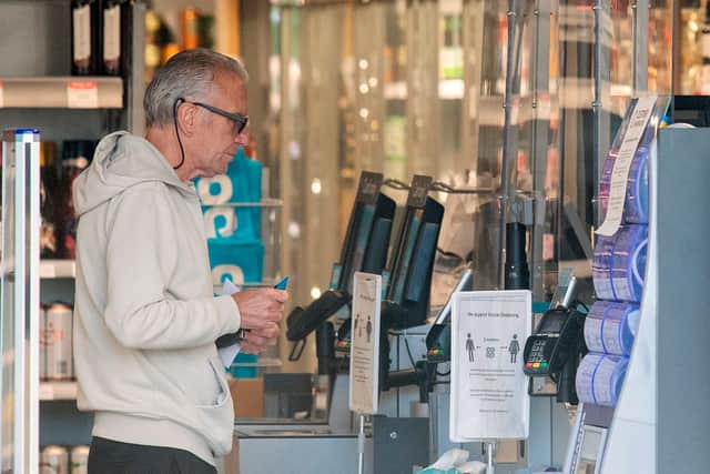 A customer at a Co-Op store. The retailer will open or refurbish 50 stores by Christmas, investing over £200 million in its UK estate (Photo: JUSTIN TALLIS/AFP via Getty Images)