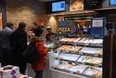 People queue at a counter inside a Greggs bakery in central London. The bakery chain has launched a new smaller 'Bitesize' store format for busy locations (Photo: JUSTIN TALLIS/AFP via Getty Images)