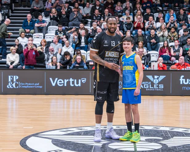 Newcastle Eagles captain Darius Defoe presenting Luke Hedley with his prestigious gold Blue Peter badge.
