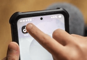 A young girl using social media app TikTok on their mobile phone, in Leeds. Children who spend more than three hours a day on social media are more likely to develop mental health problems such as depression and anxiety as teenagers, according to research.