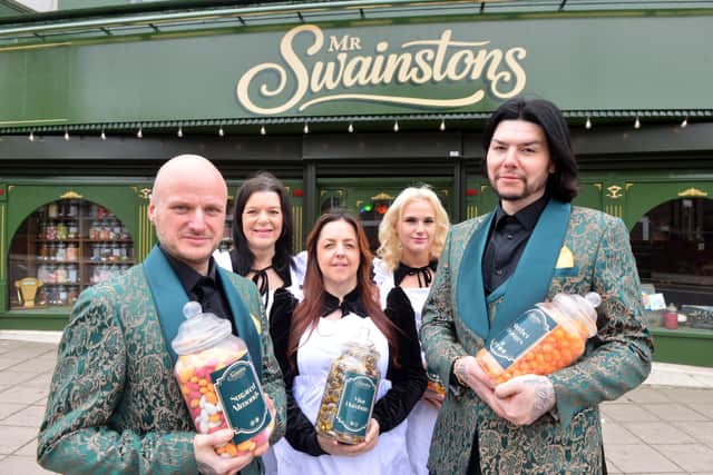 Mr Swainston's owners John Gray (left) and Sean Robinson (right) with the team outside of their new Fowler Street shop.