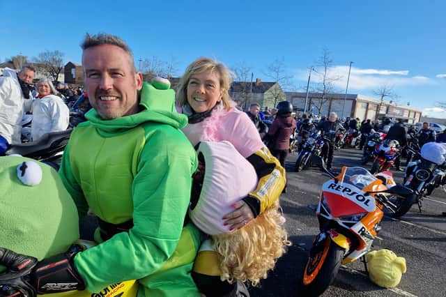 Kevin and Alana pose for another photo, this time without their fancy dress biker helmets.
