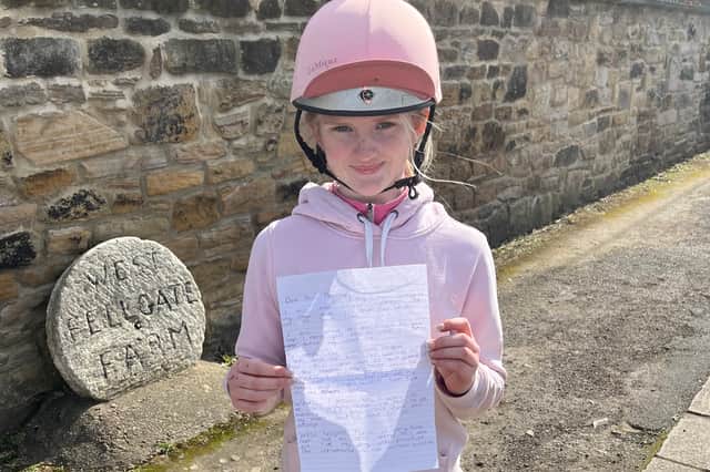 Scarlett Milner, 12, with a copy of her letter to King Charles.