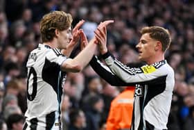 Anthony Gordon of Newcastle United celebrates scoring his team's first goal with teammate Harvey Barnes during the Premier League match between Chelsea and Newcastle United at Stamford Bridge on March 14, 2026 in London, England. (Photo by Mike Hewitt/Getty Images)