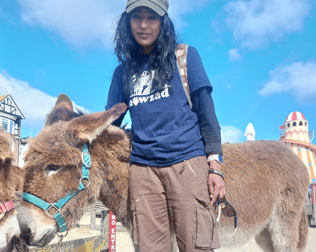 Vijay pictured with one of the donkeys she met earlier this month on a 50-mile fundraising walk for Nowzad along the Jurassic Coast.