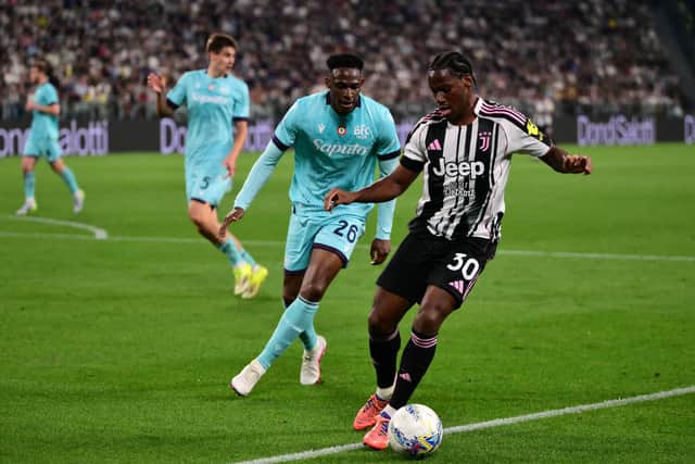 Bologna defender Jhon Lucumi challenges Juventus star Jonathan David.