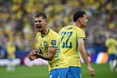 Brazil's midfielder #08 Bruno Guimaraes (L) reacts after Brazil's forward #22 Gabriel Martinelli (R) scored his steam's second goal  during the 2026 World Cup round of 32 football match between Brazil and Japan at the Houston Stadium in Houston on June 29, 2026.  (Photo by Paul ELLIS / AFP via Getty Images)