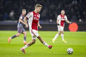 Ajax's Dutch midfielder #48 Sean Steur (C) passes the ball during the UEFA Champions League, league phase - matchday 8, football match between Ajax and Olympiakos at the Johan Cruijff Arena, in Amsterdam on January 28, 2026. (Photo by Olaf Kraak / ANP / AFP via Getty Images) / Netherlands OUT