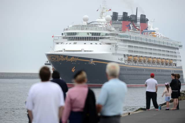 Young and old gathered on the shoreline to watch as a giant of the seas went past.